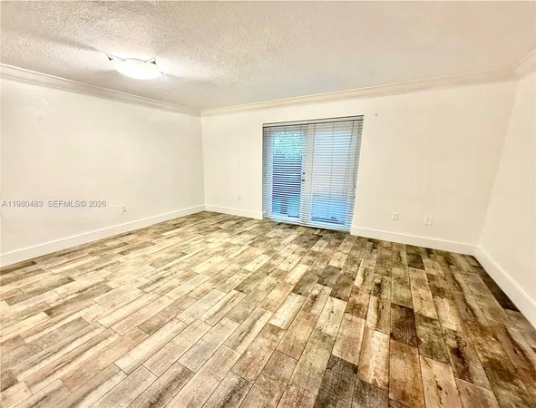 an empty room with wooden floor