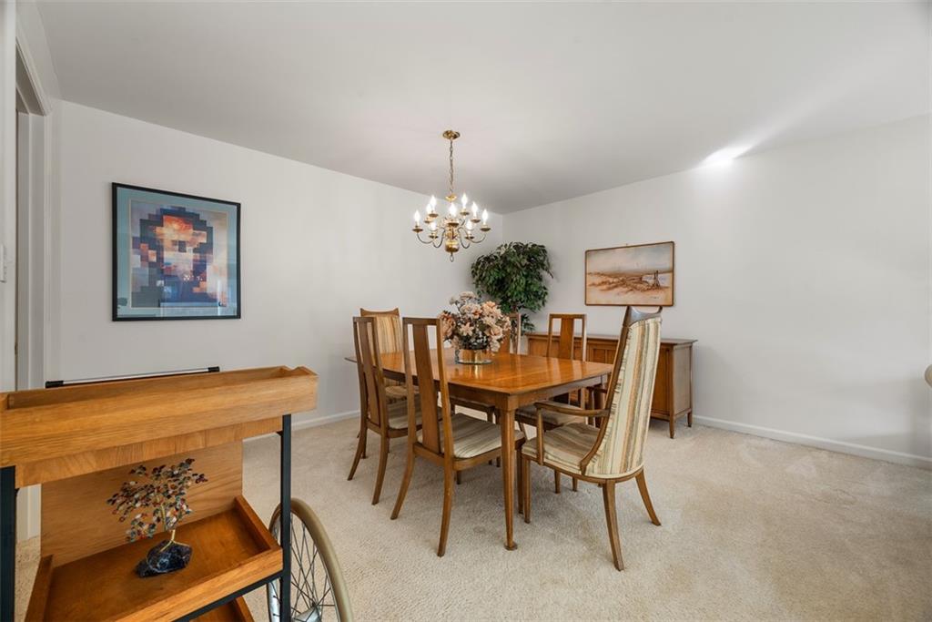 302 Fox Chapel Road, Unit 613 Pittsburgh, PA 15238 - Photo 11 of 37 a dining room with furniture and chandelier