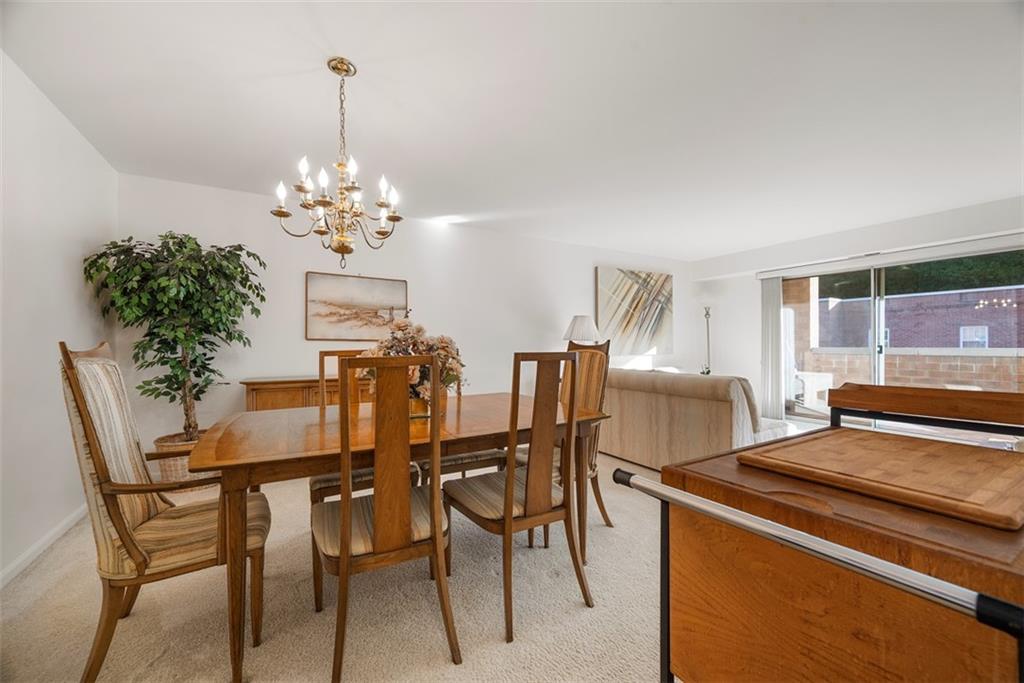 302 Fox Chapel Road, Unit 613 Pittsburgh, PA 15238 - Photo 12 of 37 a view of a dining room with furniture and chandelier