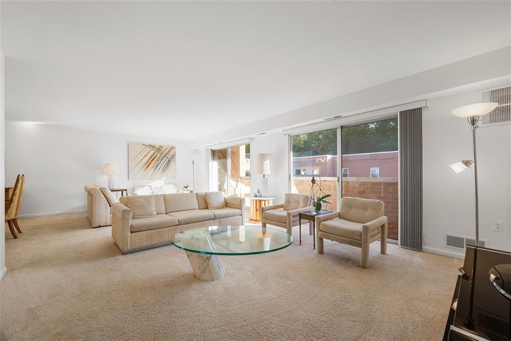 302 Fox Chapel Road, Unit 613 Pittsburgh, PA 15238 - Photo 13 of 37 a living room with furniture and a potted plant