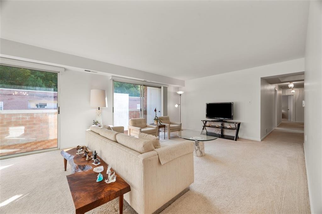 302 Fox Chapel Road, Unit 613 Pittsburgh, PA 15238 - Photo 14 of 37 a living room with furniture and a flat screen tv