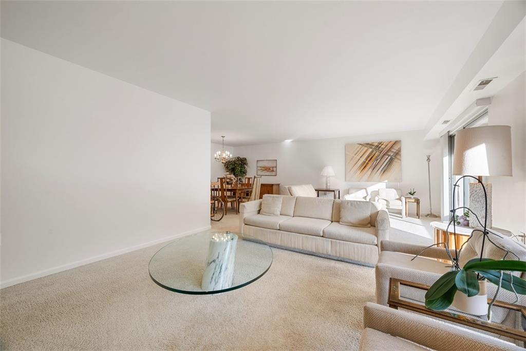 302 Fox Chapel Road, Unit 613 Pittsburgh, PA 15238 - Photo 16 of 37 a living room with furniture a lamp and a potted plant