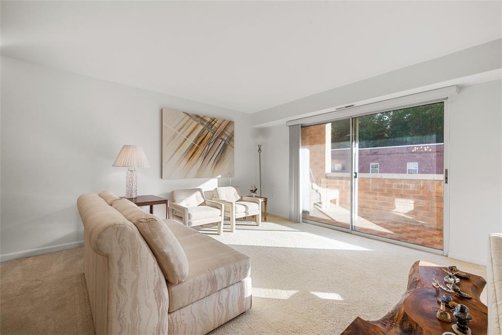 302 Fox Chapel Road, Unit 613 Pittsburgh, PA 15238 - Photo 17 of 37 a living room with furniture and a window