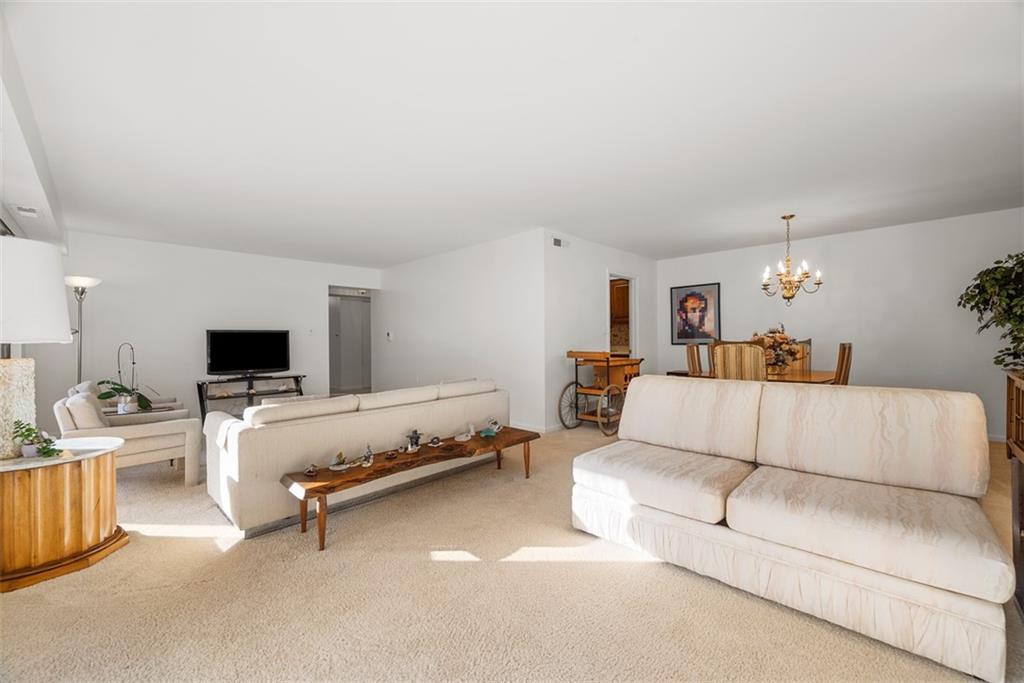 302 Fox Chapel Road, Unit 613 Pittsburgh, PA 15238 - Photo 18 of 37 a living room with furniture and a flat screen tv