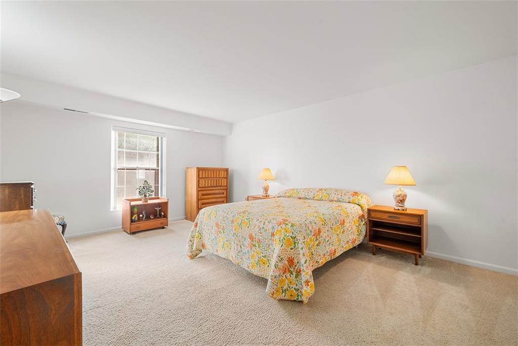 302 Fox Chapel Road, Unit 613 Pittsburgh, PA 15238 - Photo 21 of 37 a spacious bedroom with a bed and a couch