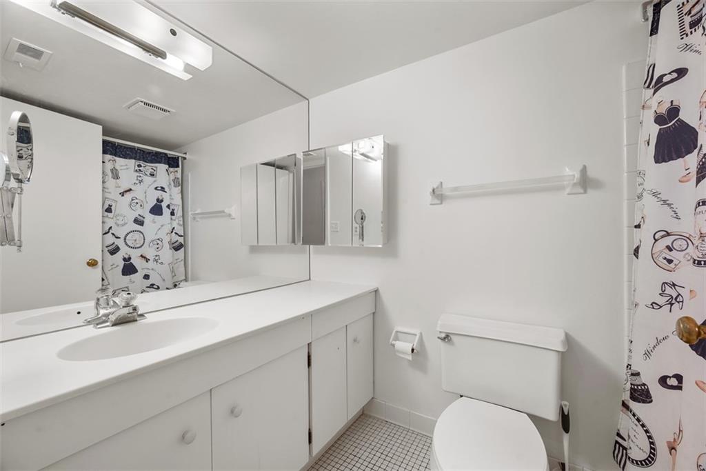 302 Fox Chapel Road, Unit 613 Pittsburgh, PA 15238 - Photo 23 of 37 a bathroom with a granite countertop toilet sink and mirror