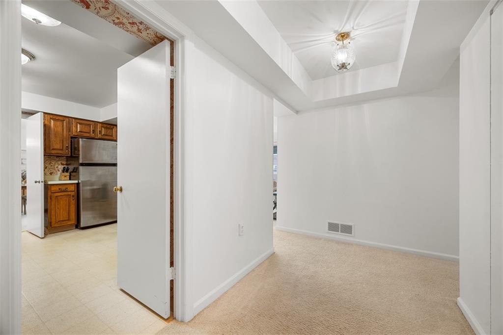 302 Fox Chapel Road, Unit 613 Pittsburgh, PA 15238 - Photo 5 of 37 a view of a kitchen with a sink and refrigerator
