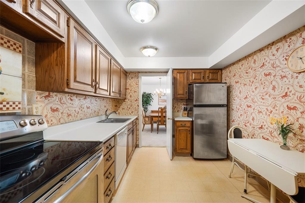 302 Fox Chapel Road, Unit 613 Pittsburgh, PA 15238 - Photo 7 of 37 a kitchen with refrigerator and cabinets