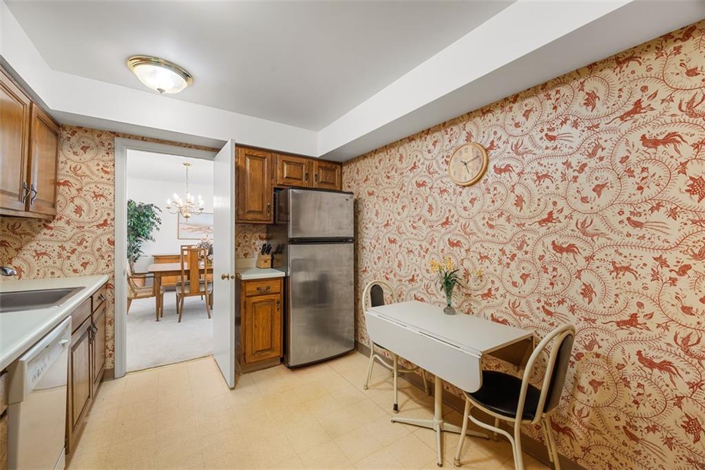 302 Fox Chapel Road, Unit 613 Pittsburgh, PA 15238 - Photo 8 of 37 a kitchen with stainless steel appliances kitchen island granite countertop a refrigerator and a stove top oven