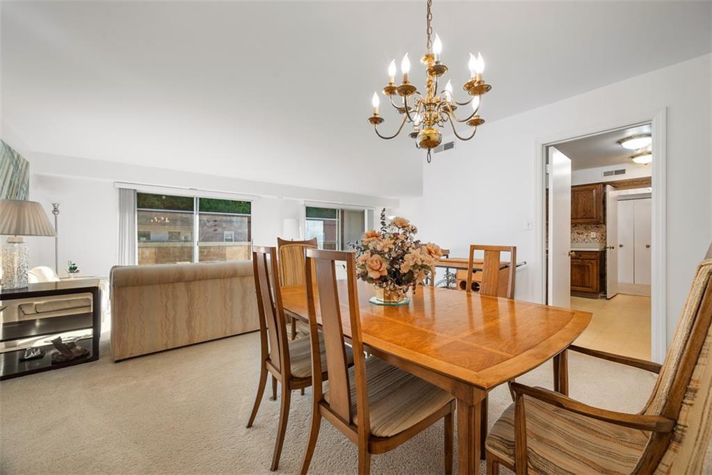 302 Fox Chapel Road, Unit 613 Pittsburgh, PA 15238 - Photo 10 of 37 a view of a dining room with furniture and chandelier