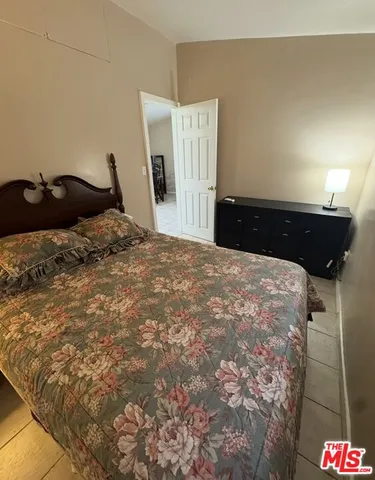 a bedroom with a bed and a cabinets