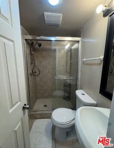a bathroom with a toilet and a shower