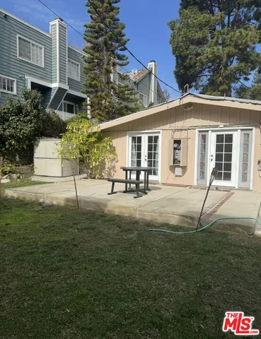 a backyard of a house with yard and outdoor seating