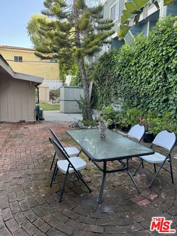 a backyard of a house with table and chairs