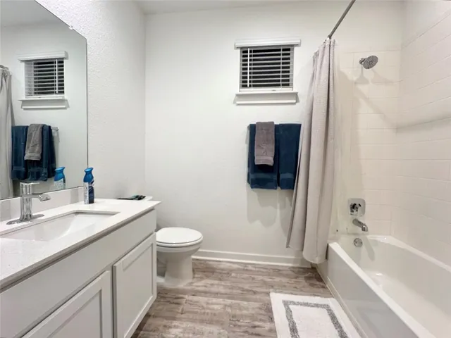 a living room with furniture and a air conditioner vent