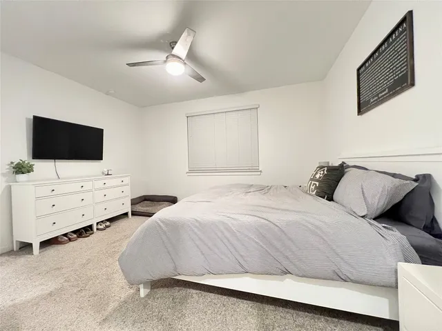 a bedroom with a bed and a couch