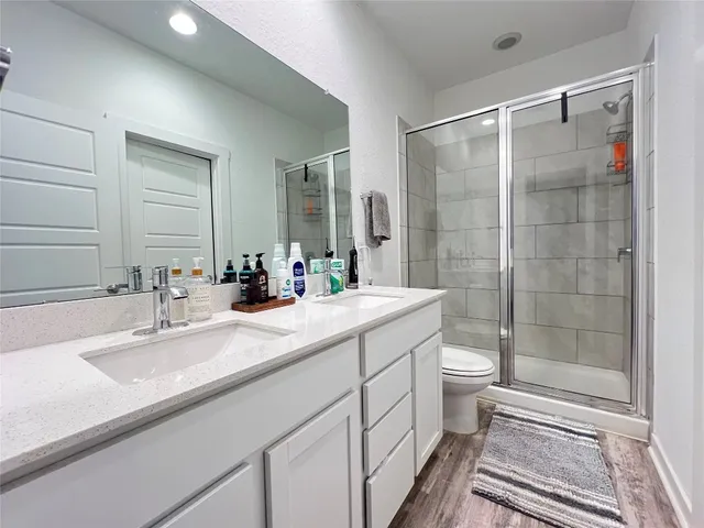 a bedroom with a bed mirror and a potted plant