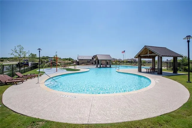 a view of a lake with houses in the back