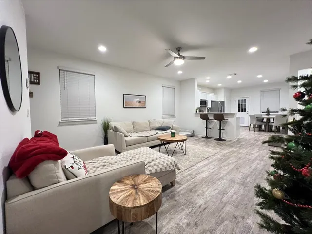 a living room with furniture and a chandelier