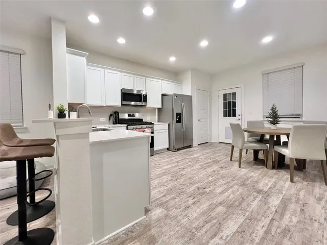 a kitchen with a sink and a stove top oven