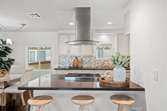 a kitchen with stainless steel appliances granite countertop a lot of counter space and wooden floor