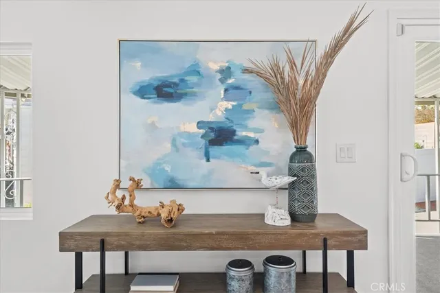 a table with a vase and flowers on it