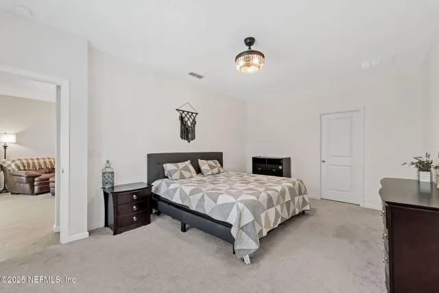 a large bed sitting in a bedroom and table