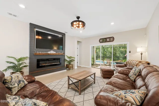 a living room with furniture a fireplace and a flat screen tv