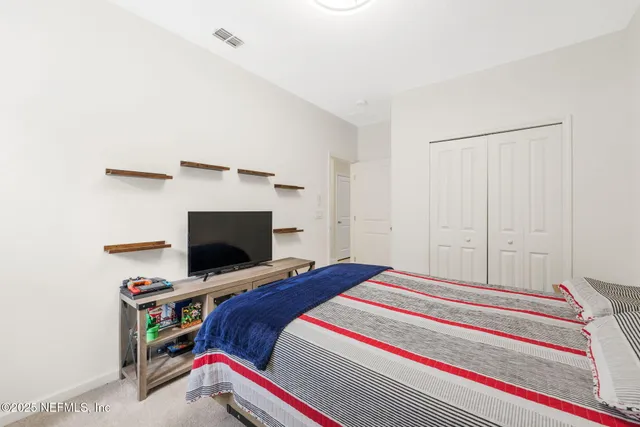 a view of a patio with a table and chairs under an umbrella