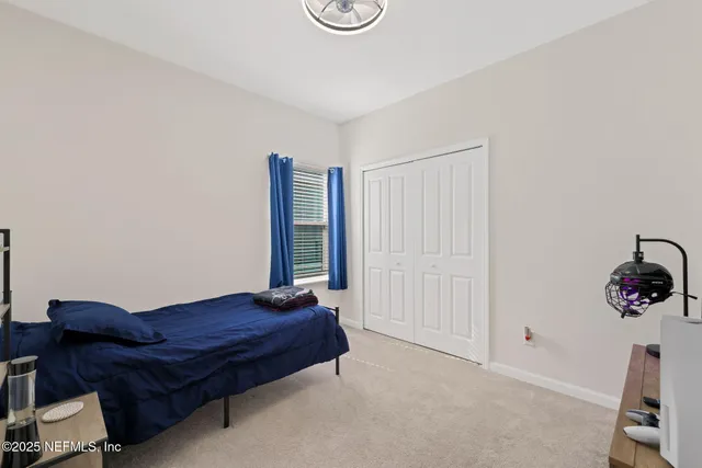 a aerial view of a house next to a yard