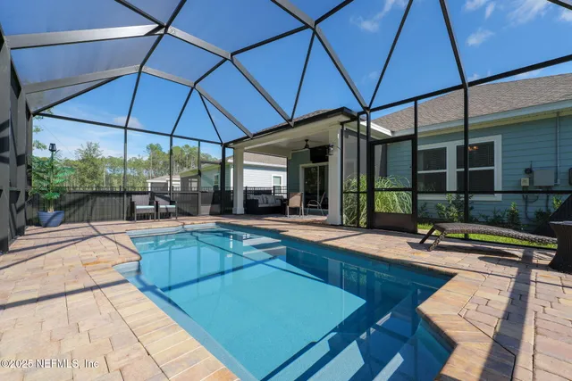 a view of swimming pool with outdoor seating and plants
