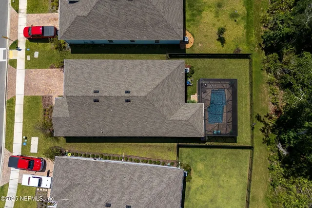 a view of a street with a bench and trees