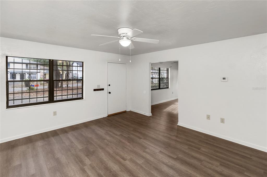 1018 Southwest 60 Terrace, Unit A Gainesville, FL 32607 - Photo 4 of 11 wooden floor in an empty room with a window