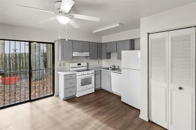 a kitchen with white cabinets and white appliances