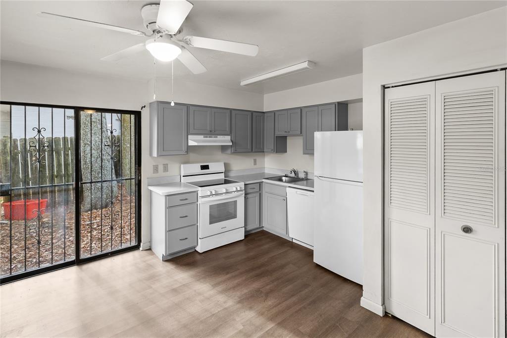 1018 Southwest 60 Terrace, Unit A Gainesville, FL 32607 - Photo 5 of 11 a kitchen with white cabinets and white appliances
