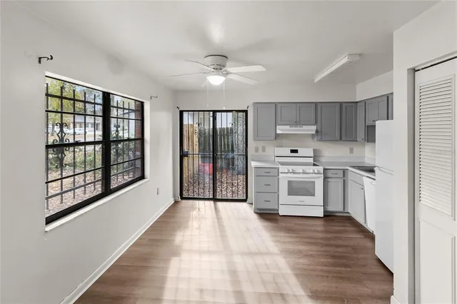 a kitchen with stainless steel appliances a stove a sink and a refrigerator