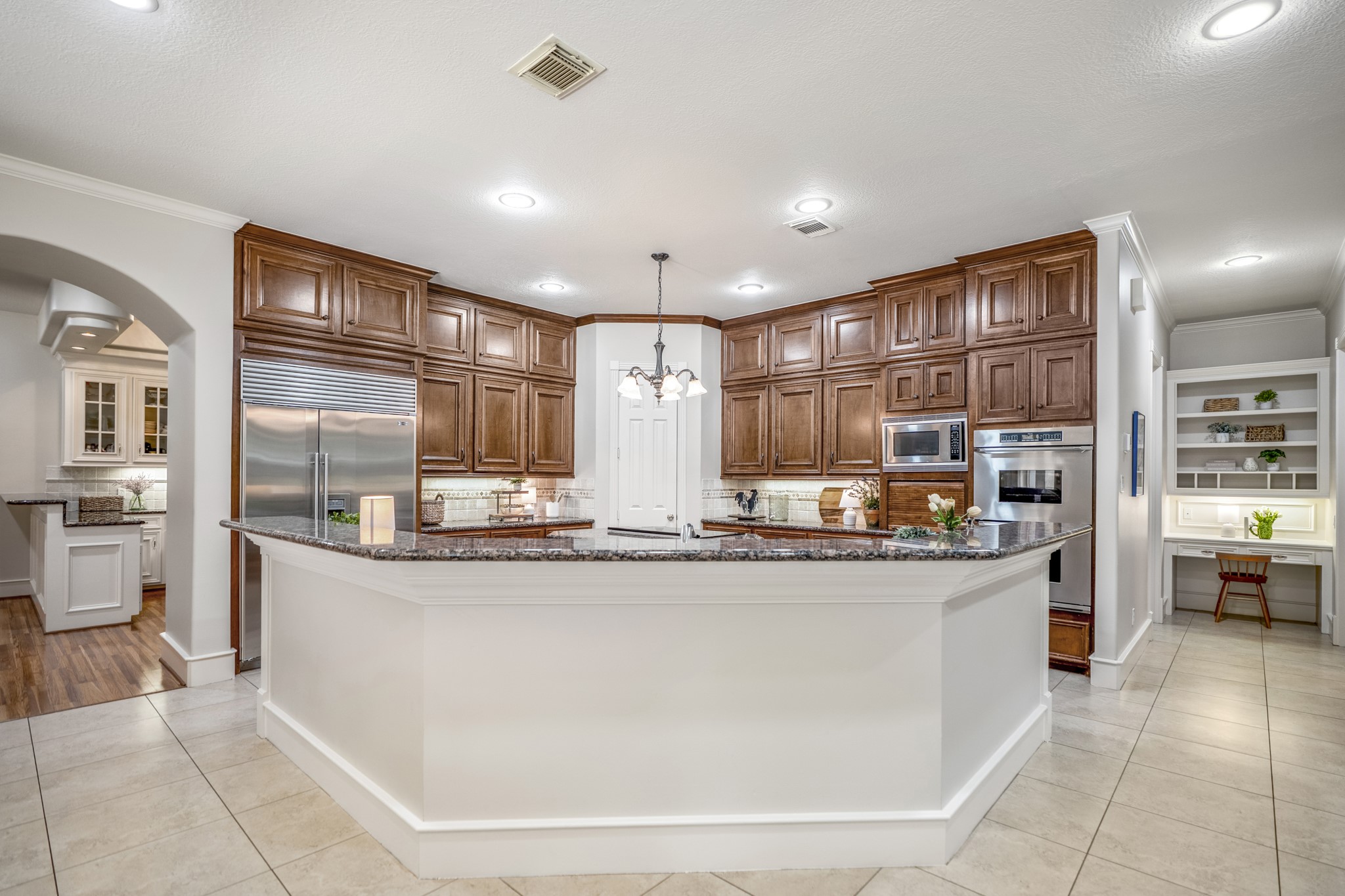 8806 Sterling Gate Circle Spring, TX 77379 - Photo 14 of 40 This view of the kitchen shows the expansive breakfast bar with plenty of counter space for several bar stools.