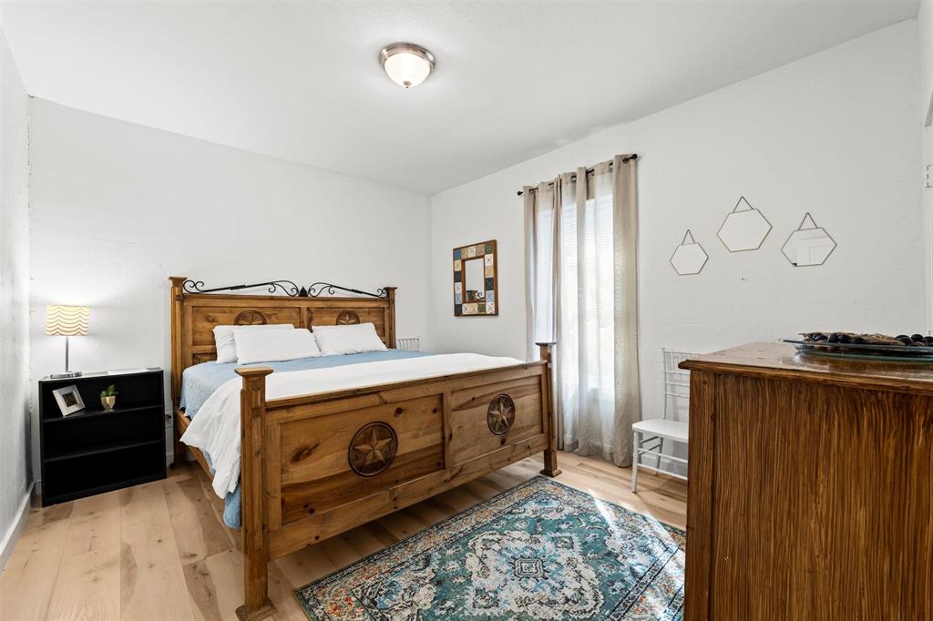 3100 North 27th Street Waco, TX 76708 - Photo 11 of 27 a bedroom with a bed and wooden floor