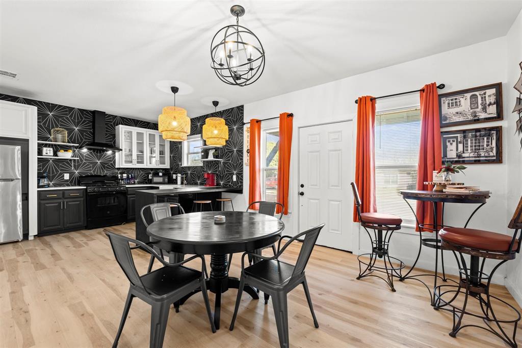 3100 North 27th Street Waco, TX 76708 - Photo 2 of 27 a kitchen with a dining table and chairs