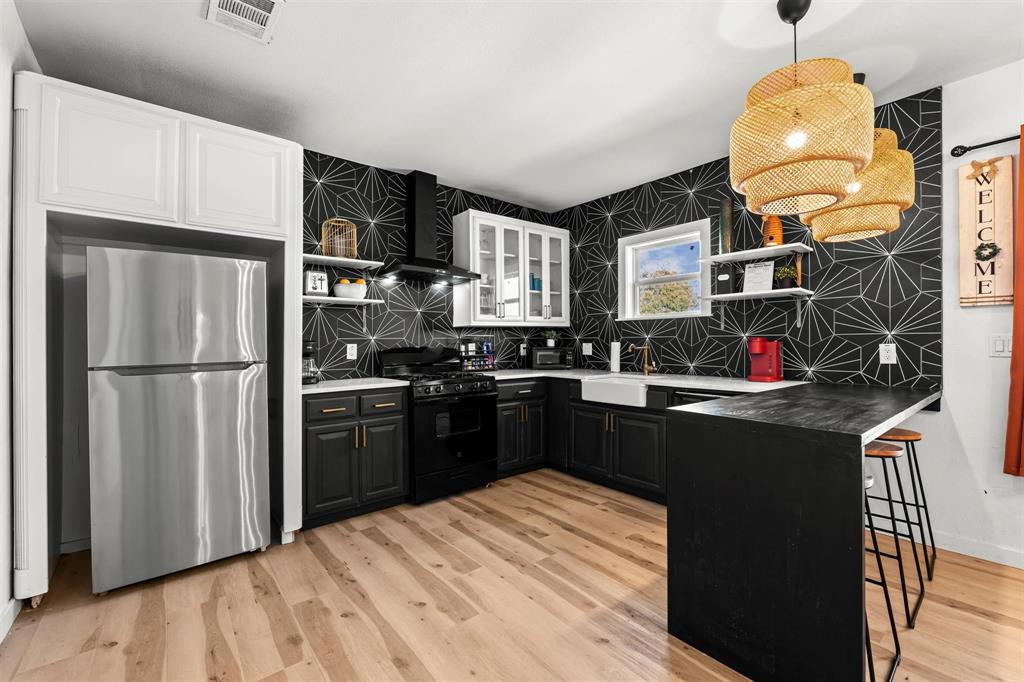 3100 North 27th Street Waco, TX 76708 - Photo 3 of 27 a kitchen with stainless steel appliances granite countertop a refrigerator a stove a sink and a microwave