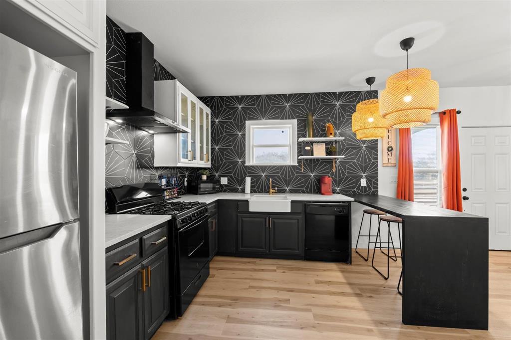 3100 North 27th Street Waco, TX 76708 - Photo 4 of 27 a kitchen with stainless steel appliances granite countertop a refrigerator a stove and a sink