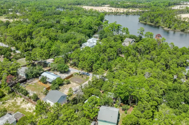 an aerial view of a house with outdoor space and lake view