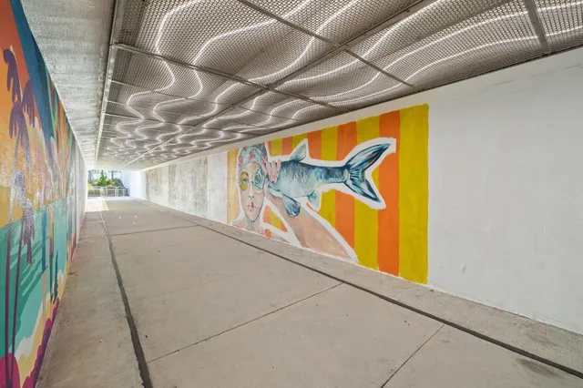 a front view of a building with palm trees