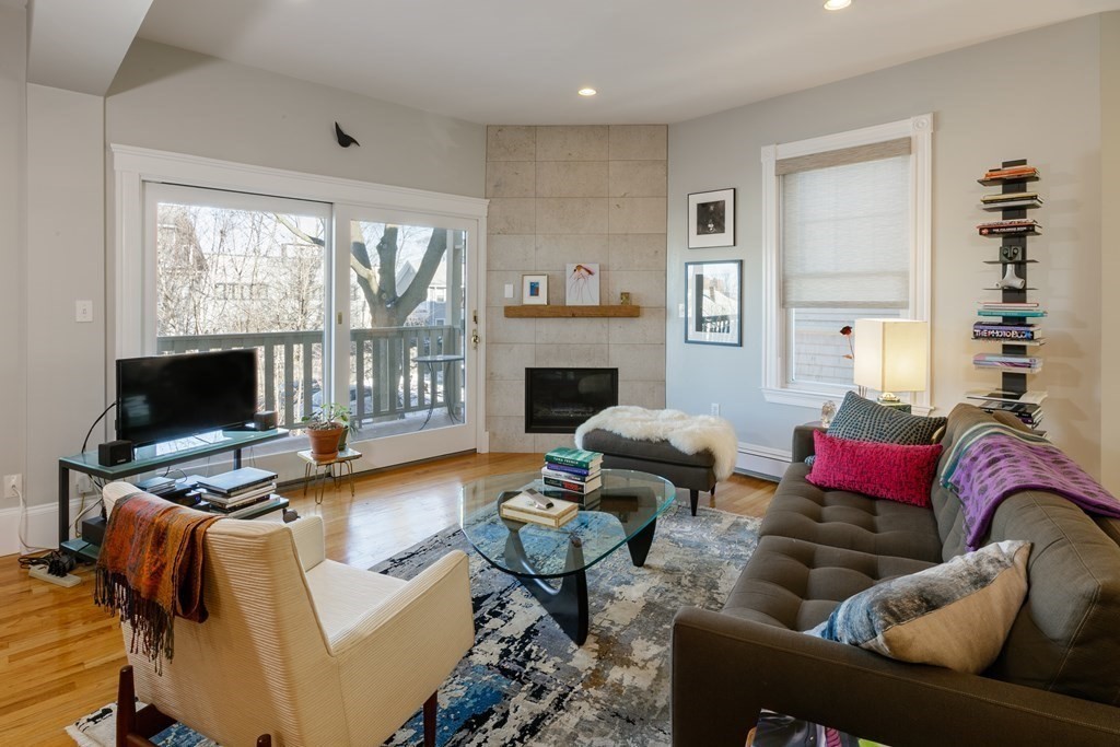 a living room with furniture fireplace and a flat screen tv