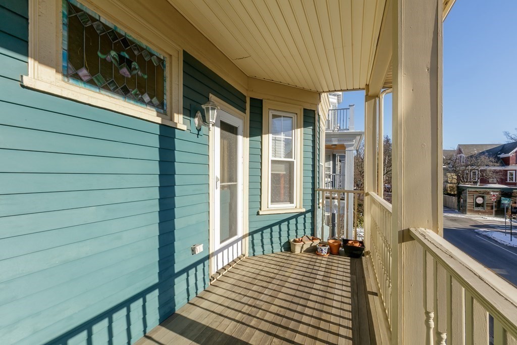 273-275 Concord Avenue, Unit 2 Cambridge, MA 02138 - Photo 20 of 24 a view of a balcony with wooden floor and stairs