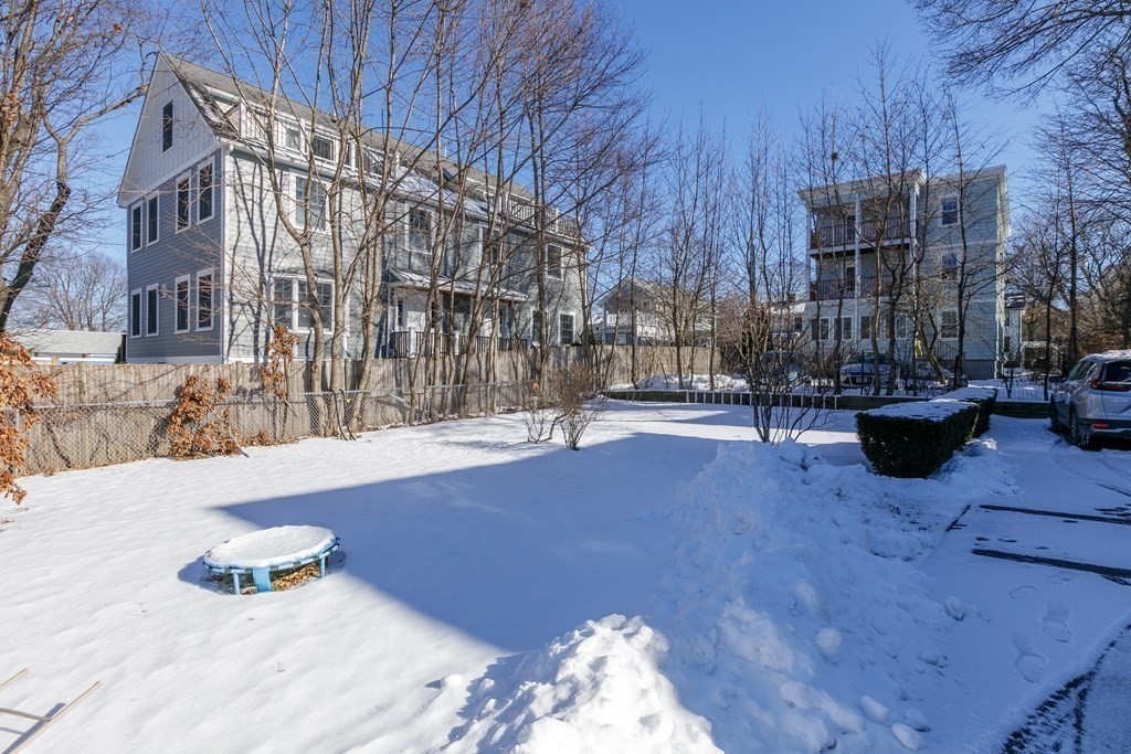 273-275 Concord Avenue, Unit 2 Cambridge, MA 02138 - Photo 23 of 24 a backyard of a house with cars parked on road