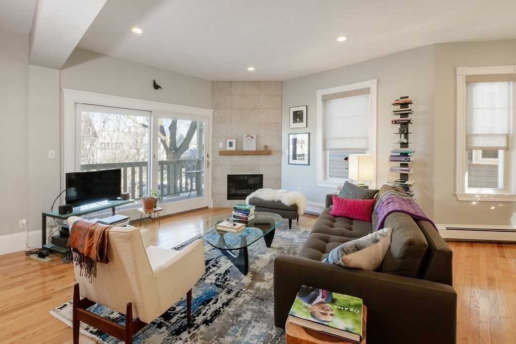 273-275 Concord Avenue, Unit 2 Cambridge, MA 02138 - Photo 3 of 24 a living room with furniture fireplace and a flat screen tv