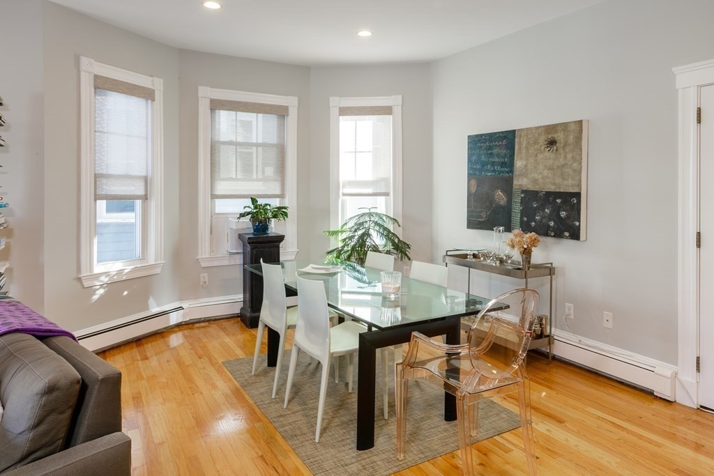 273-275 Concord Avenue, Unit 2 Cambridge, MA 02138 - Photo 5 of 24 a view of a dining room with furniture and wooden floor