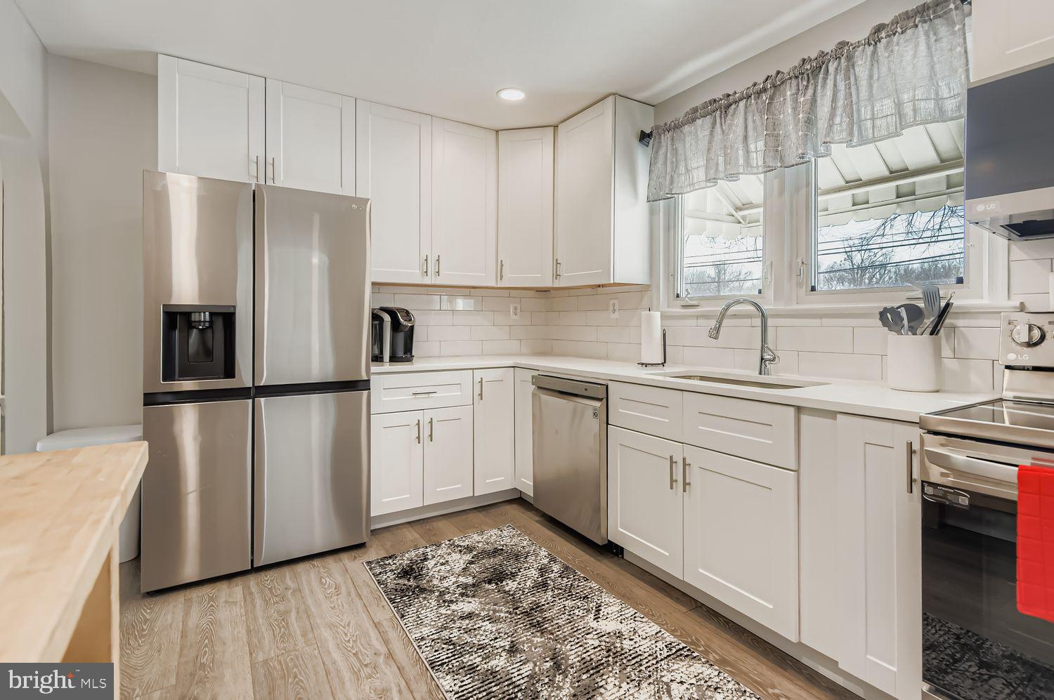 107 Calvary Road Churchville, MD 21028 - Photo 6 of 31 a kitchen with white cabinets and white appliances