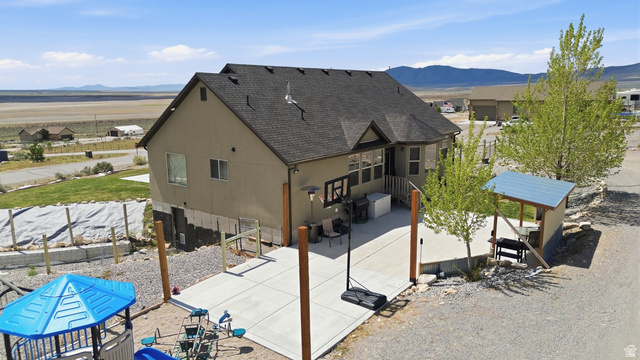 1588 West Rim Rock Drive Stockton, UT 84071 - Photo 58 of 61 Neutral-toned stucco exterior with a dark shingle roof